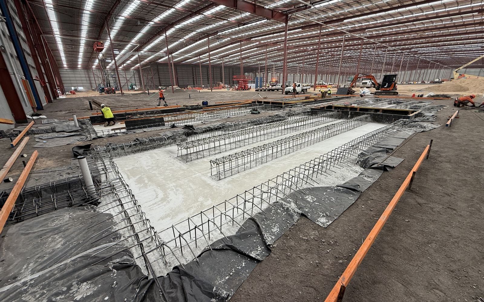 Reinforcement, membrane and formwork set out for a recessed slab inside a steel-framed warehouse