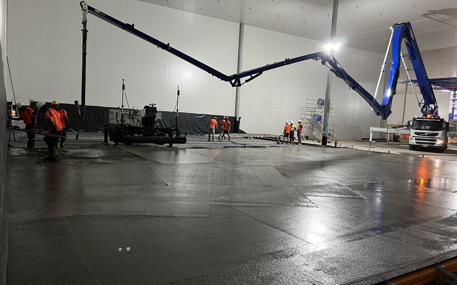 A freshly placed wearing slab across the floor of a refrigerated chamber